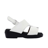 Pair of FARES brand white leather sandals with black soles and adjustable heel straps, featuring a modern geometric cutout design on a white background.