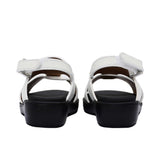 Pair of FARES brand white leather sandals with black soles and adjustable heel straps, featuring a modern geometric cutout design on a white background.