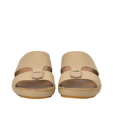 Front-facing view of a pair of FARES beige leather comfort sandals showcasing the wide toe-box opening and matching shield-shaped matte metallic buckle details on the front straps against a white background.