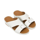 An overhead, three-quarter angle view of a pair of FARES beige sandals showing the smooth tan leather footbeds and the premium perimeter stitching along the midsoles against a white background.
