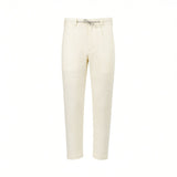 Off-white jogger pants with a textured fabric, elasticated waistband, grey drawstring, and tapered legs.