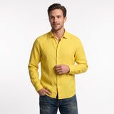 Ochre long-sleeved linen shirt with a standard collar, full button placket, and off-white buttons.