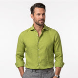 Ochre long-sleeved linen shirt with a spread collar and light-coloured buttons.