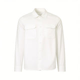 White long-sleeved overshirt with a pointed collar, full button front, and two button-flap chest pockets with a subtle crinkl