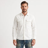 Men's white corduroy overshirt with a collared neckline, button-front, and two buttoned chest pockets.