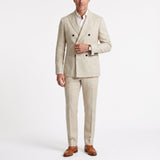 Ecru double-breasted linen suit with notched lapels, patch pockets, and dark buttons, paired with matching straight-leg trous