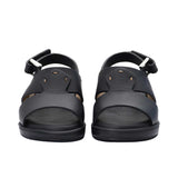 Pair of FARES brand smooth leather sandals with silver buckles and adjustable heel straps, featuring a modern minimalist design on a white background.