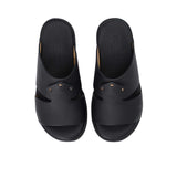 A pair of FARES kids' leather slip-on Arabic sandals with a minimalist wide-strap design and cushioned.