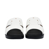 A pair of FARES kids' leather slip-on Arabic sandals with a minimalist wide-strap design and cushioned.
