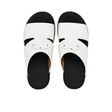 A pair of FARES kids' leather slip-on Arabic sandals with a minimalist wide-strap design and cushioned.