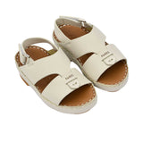 Pair of FARES  textured leather sandals with tan footbeds, visible perimeter stitching, and adjustable heel straps on a white background.
