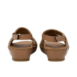 Pair of FARES brand tan pebbled leather sandals with gold-tone buckles and a metallic center stud accent, featuring visible hand-stitching on a white background.