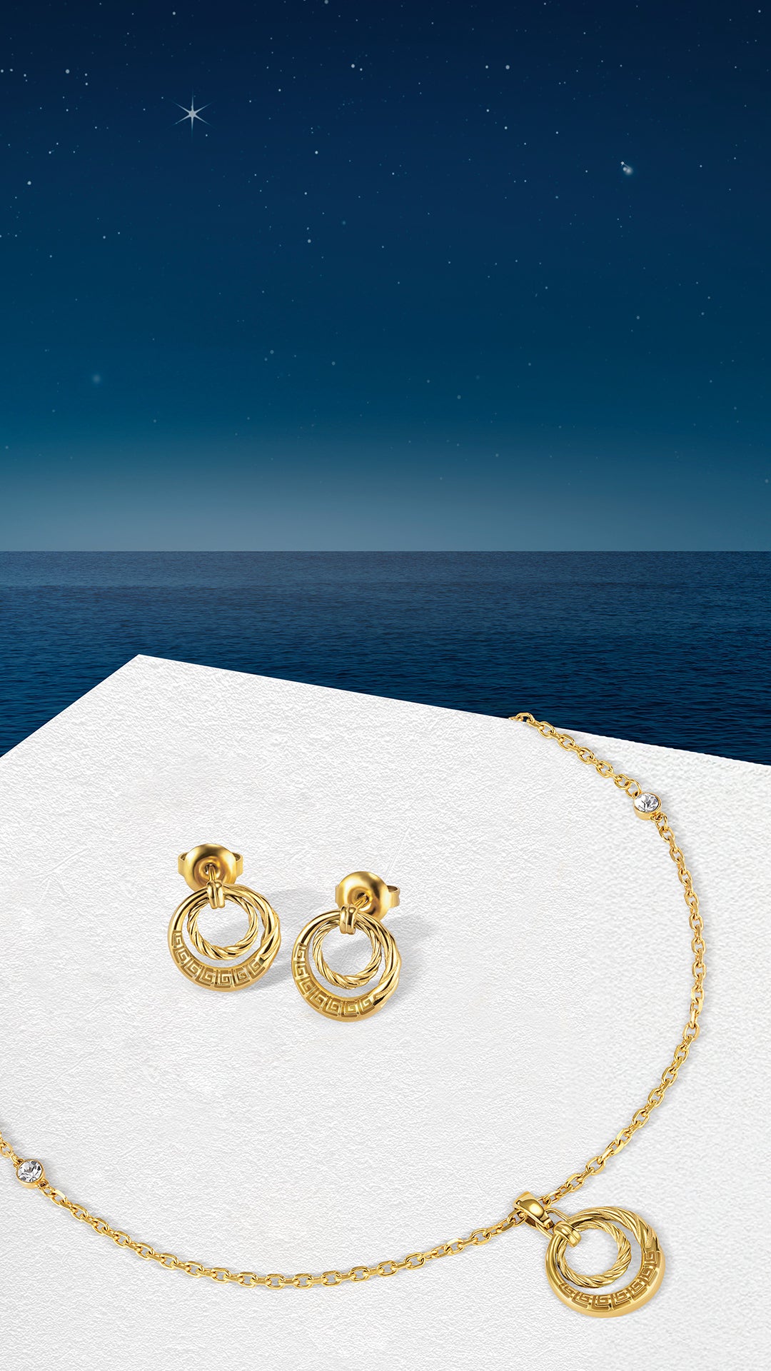 Pair of gold-toned stud earrings, each with a twisted inner ring and an outer ring featuring a Greek key pattern.