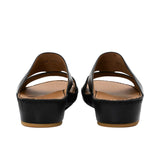 Rear view showing the heel elevation and leather lining of the FARES sandals.