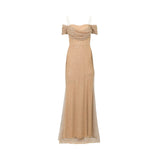 Fiordelli Donna champagne gold evening gown with off-the-shoulder draped sleeves, thin spaghetti straps, and a shimmering sequin mesh texture on a white background.