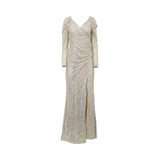 A floor-length platine sequin evening gown by Fiordelli Donna featuring a V-neckline, long sleeves with puffed shoulders, and a high side slit on a white background.