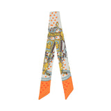 Flat View of the Muni women’s multicolor twilly scarf with orange heart motifs and equestrian print. Now Available Online
