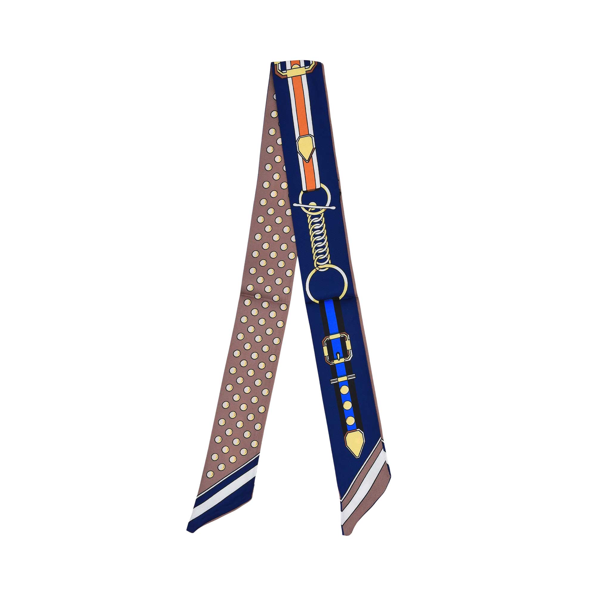 Flat view of the Muni women’s blue printed twilly scarf, with belt buckle motif and brown polka dot detailing. Available for Online Purchase