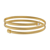 A front-facing studio perspective of the Saint Honoré Tubogas three-lyre gold-plated coiled bangle, showcasing the square-bezel solitaire crystal terminal and the stamped SH logo cap.