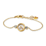 A high-resolution studio shot of the Aigner Fina women's luxury bracelet, showcasing its radiant yellow gold-plated stainless steel chain construction, the central polished 'A' horseshoe monogram emblem, and the delicate adjustable clasp system completed with an engraved Aigner logo charm.
