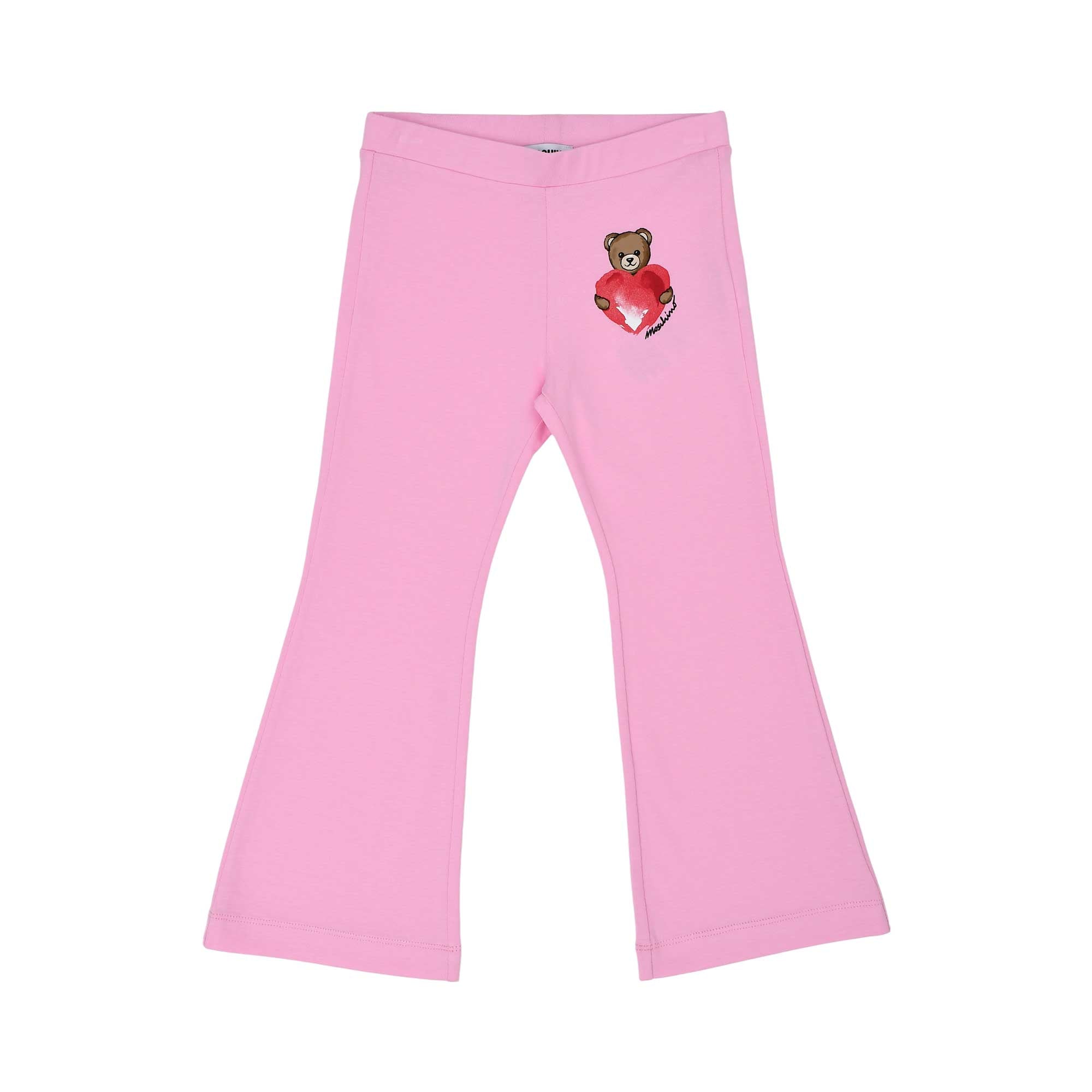 Front trousers view of the Moschino kids girls white T-shirt and pink trousers teddy print set. Shop Now Online