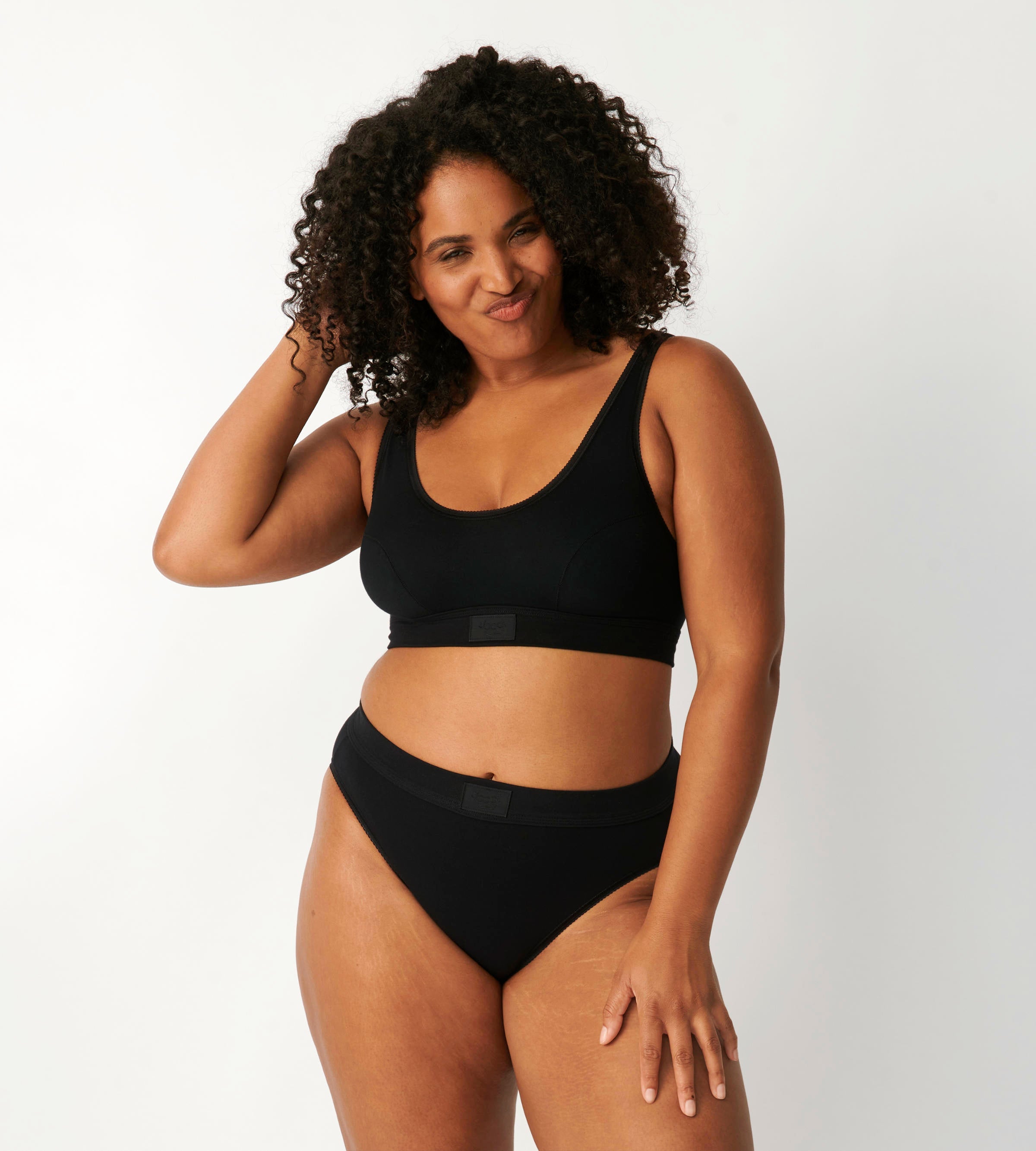 Front view of model wearing the Sloggi Ever Ease black Tai panty, showcasing the high-cut leg and smooth, soft fabric texture. Available for Online Purchase