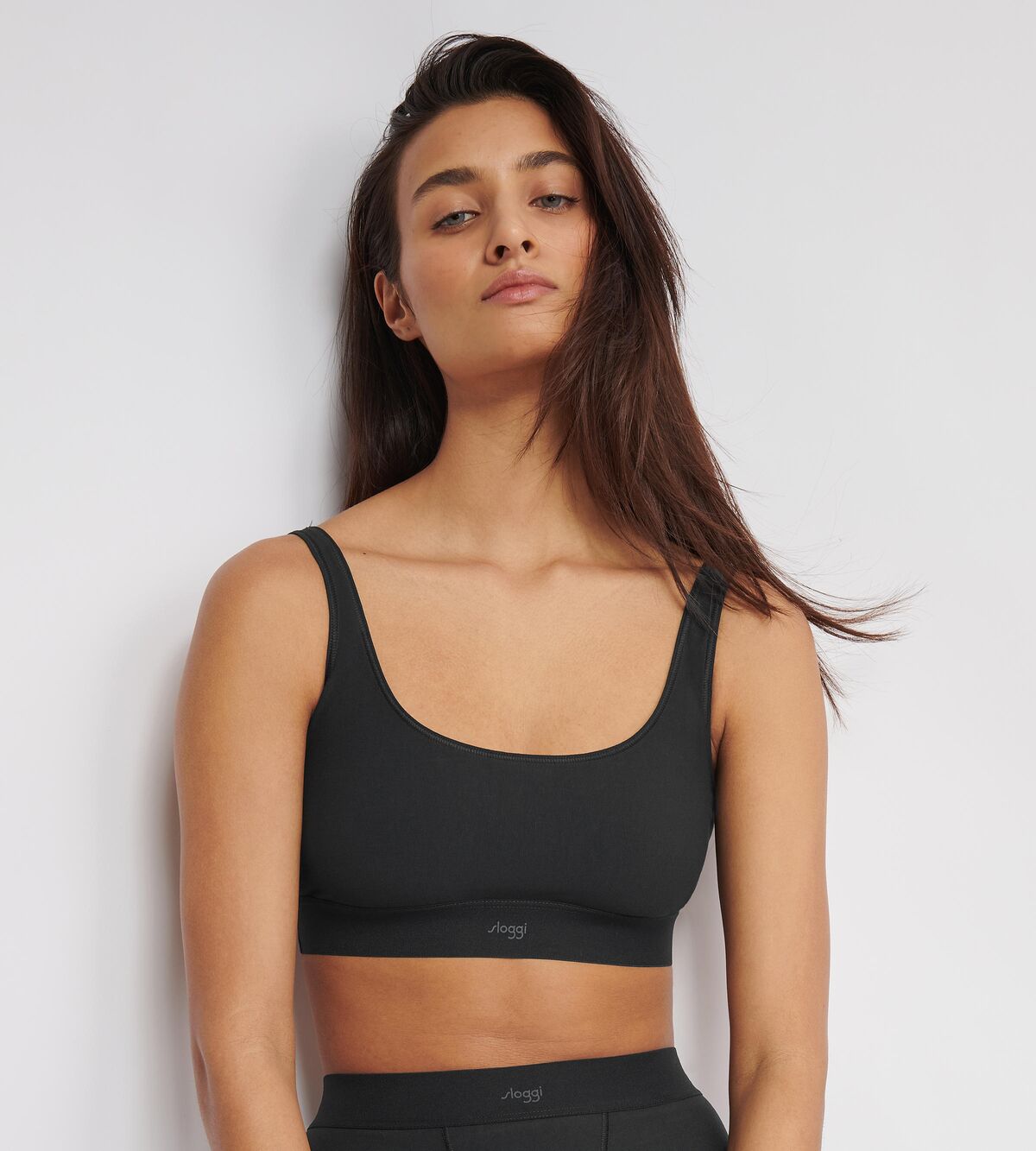 Front view of model wearing the Sloggi Ever Ease black bra top, showing the wide shoulder straps and seamless, wire-free design. Available Now Online