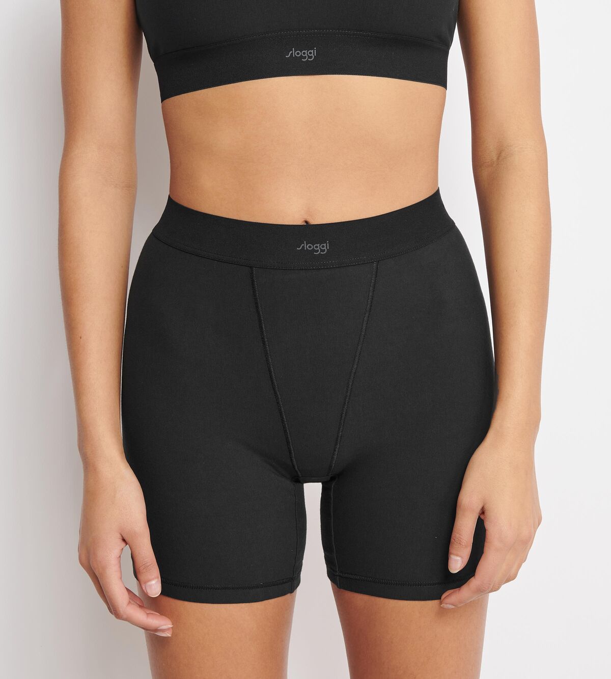 Front view of model wearing the Sloggi Ever Ease black cyclist shorts, showcasing the mid-thigh length and smooth, seamless construction. Shop the Latest Online