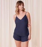 Front view of model wearing the Triumph Silky Sensuality navy pajama set, showcasing the lace-trimmed top and the shimmering, fluid fabric. Shop Online Today