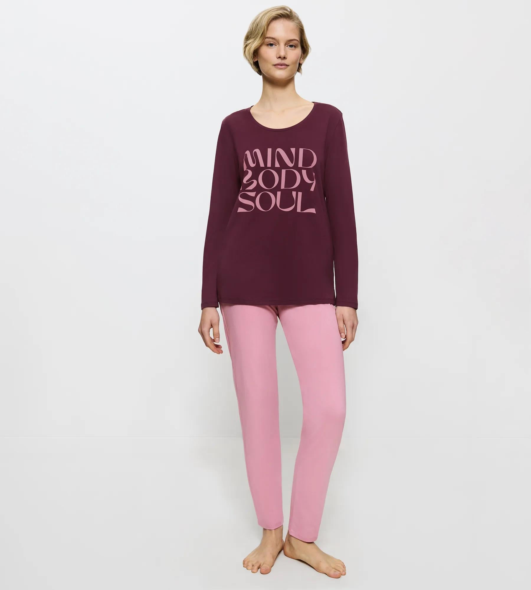 Front view of model wearing the Triumph violet and pink pajama set, highlighting the soft fabric and comfortable elasticated waistband. Shop Now Online