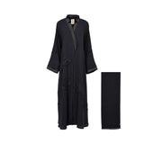 Front view of the Nero Women's Navy Blue Satin Lapel Embellished Abaya with tonal floral bead embellishment with matching scarf. Order Online Today