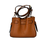 Front view of the Pourchet Blossom bucket bag in camel, showing the adjustable shoulder strap and the gold embossed brand logo on the front.