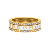 A direct front horizontal studio shot of the fully stacked Escada Eliza ring, highlighting the repeating gold-tone house logo against the white pearlescent inlay and the twin outer rows of white crystals.