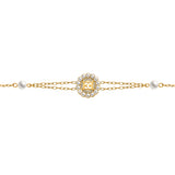 A direct, flat-lay studio photograph focusing on the detailed alignment of the Escada Clara bracelet, highlighting the crystal-accented golden EE logo inside the pearl frame and the symmetrical side pearl links.