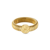A front-facing studio shot of the Saint Honoré gold-plated Tubogas ring on a clean white background, highlighting the circular coin motif engraved with the central SH monogram and brand name.