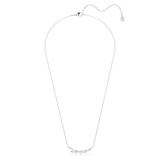 A full overhead studio layout of the Swarovski Mesmera necklace, demonstrating the complete length of the fine rhodium-plated cable chain and the elegant, low-hanging drape of the crystal centerpiece.