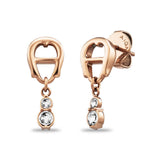 A high-resolution studio display of the Aigner Iva women's rose gold-plated stainless steel earrings, showing one piece from the front highlighting the horseshoe stud and double-crystal drop, and the other tilted to display the post and branded Aigner butterfly backing.