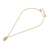 A full studio overhead shot of the Escada Grace small gold pendant necklace, displaying the delicate link chain, the oval crystal logo pendant, and the adjustable extender tail.