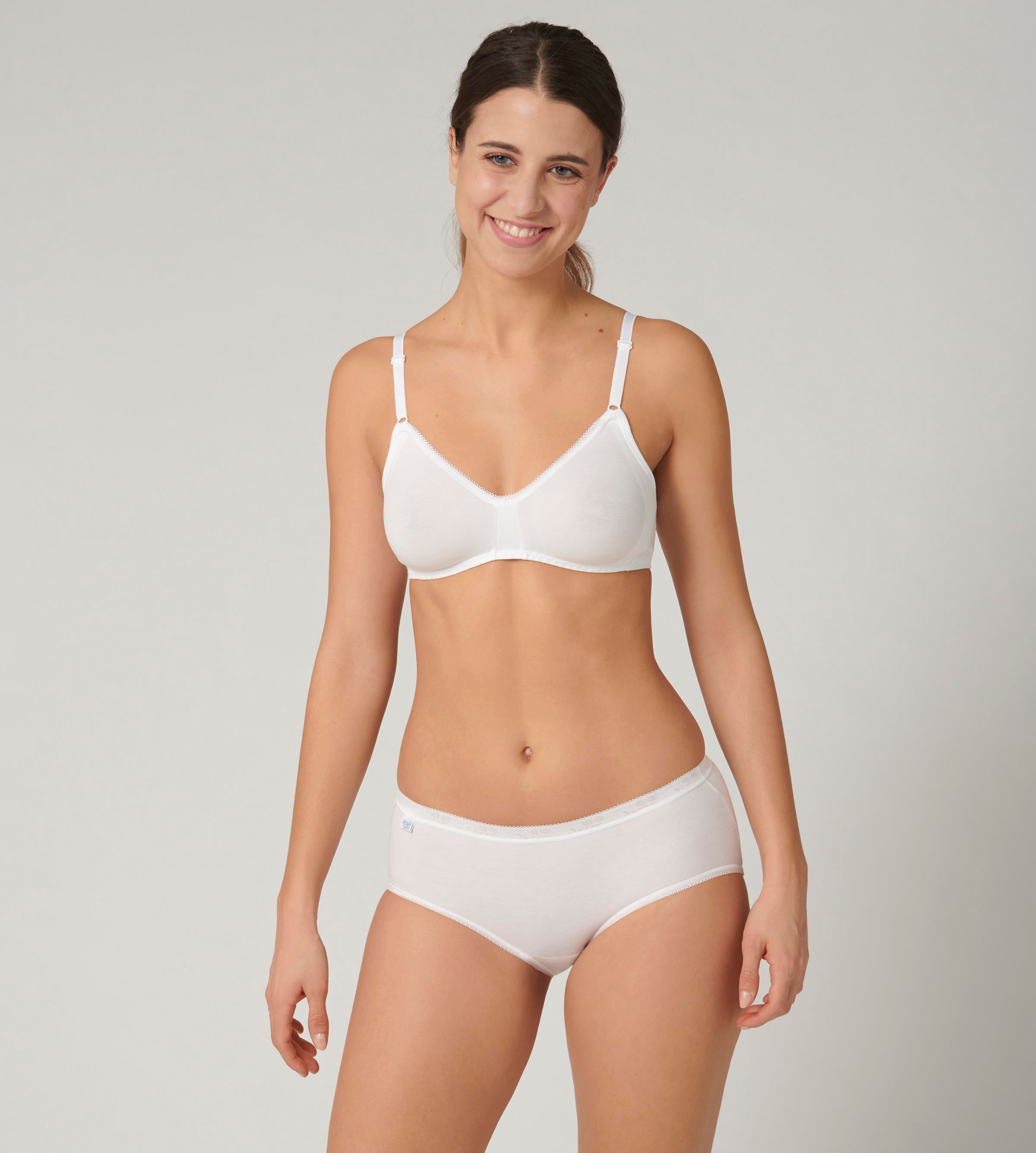 Full front view of model wearing the Sloggi Basic+ white midi panties, showing the mid-rise waist and soft, breathable cotton texture. Now Available Online