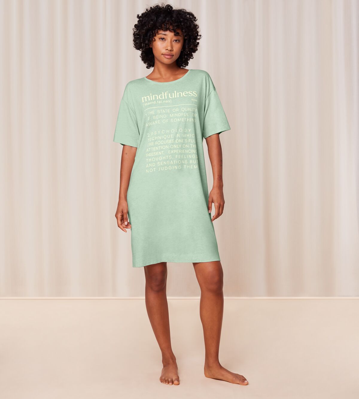 Full front view of model wearing the Triumph green short sleeve nightdress, highlighting the relaxed silhouette and soft-touch fabric. Shop the Latest Online
