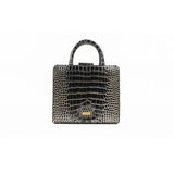 A front-facing view of the GAIA black croc-embossed leather midi bag featuring a gold-toned GAIA logo plaque at the bottom center, two rolled top handles, and a clean, symmetrical silhouette.