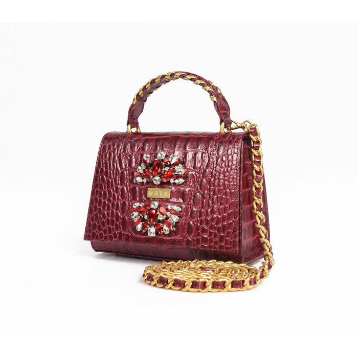 Side angle of the GAIA Victorian Mini bag showing the detachable gold chain crossbody strap and textured crocodile finish.