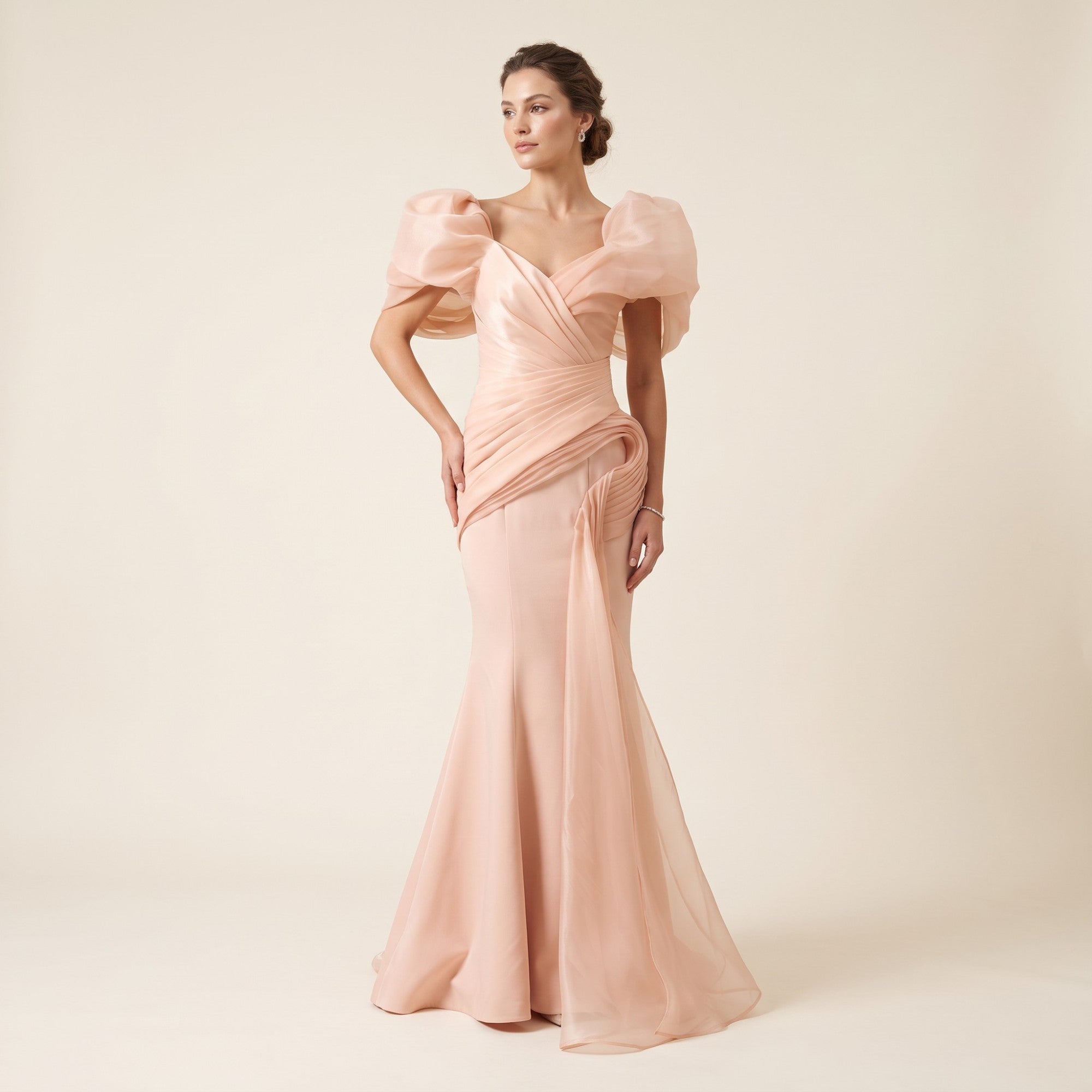 Pink mermaid-style long dress with voluminous puffed sleeves, a V-neck ruched bodice, and draped sheer fabric detailing.