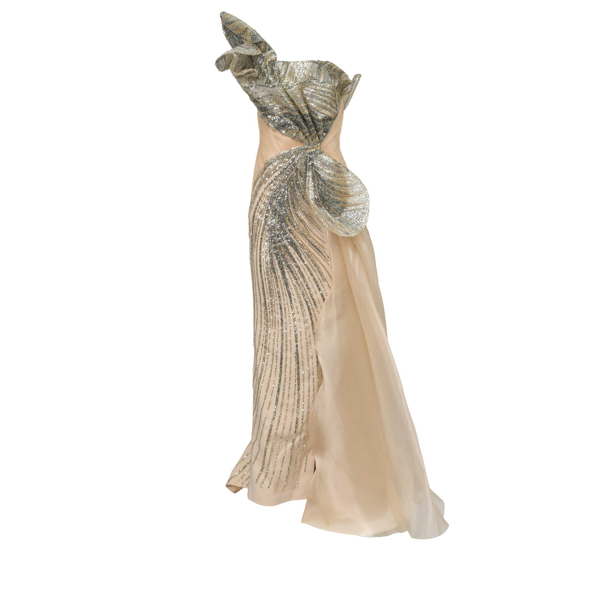 Strapless nude gown with a ruffled, multi-toned sequin bodice. Fitted skirt has vertical sequins and a sheer draped train.
