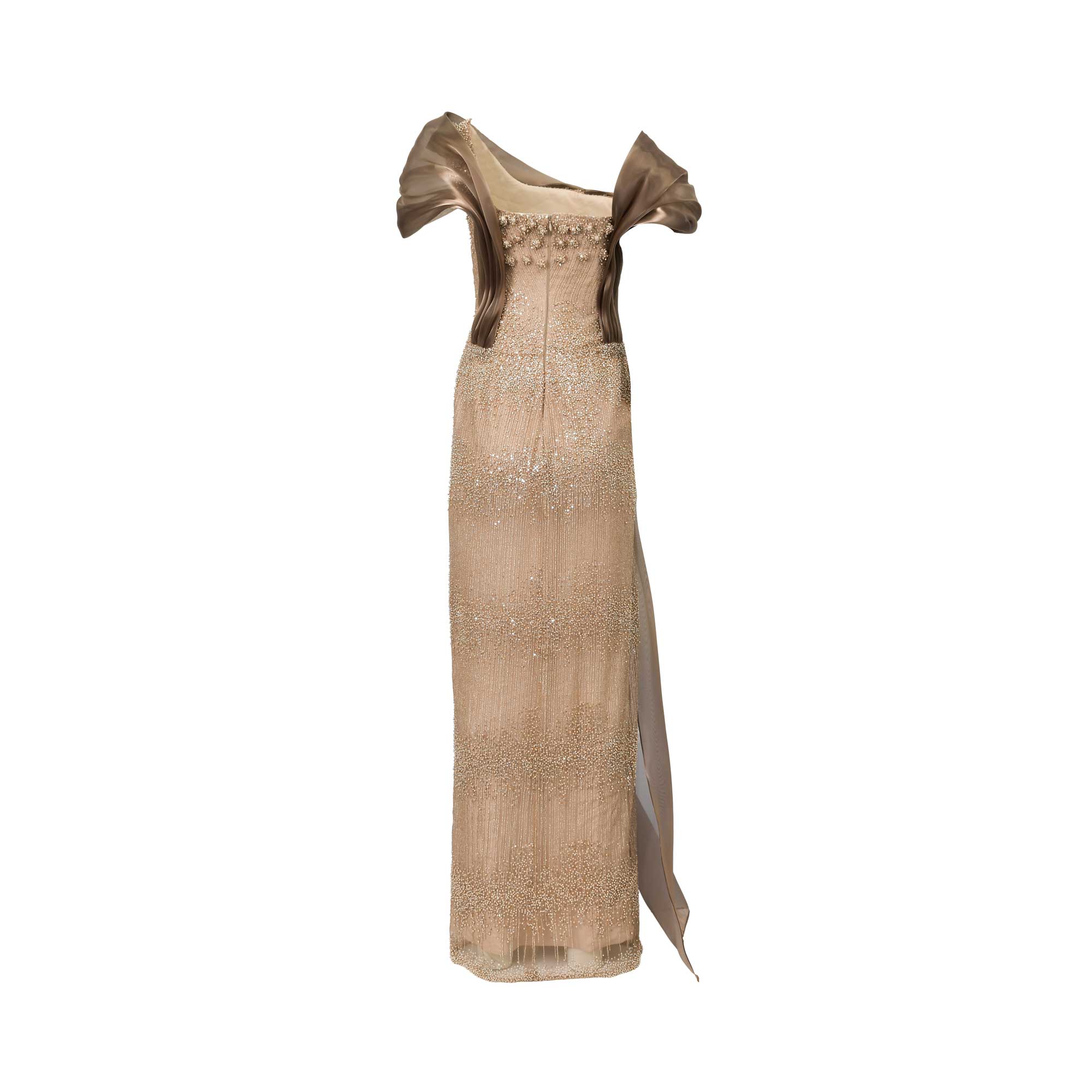 Bronze and nude floor-length gown with ruffled off-shoulder sleeves. Gold-toned beading covers the dress, with a long sash.