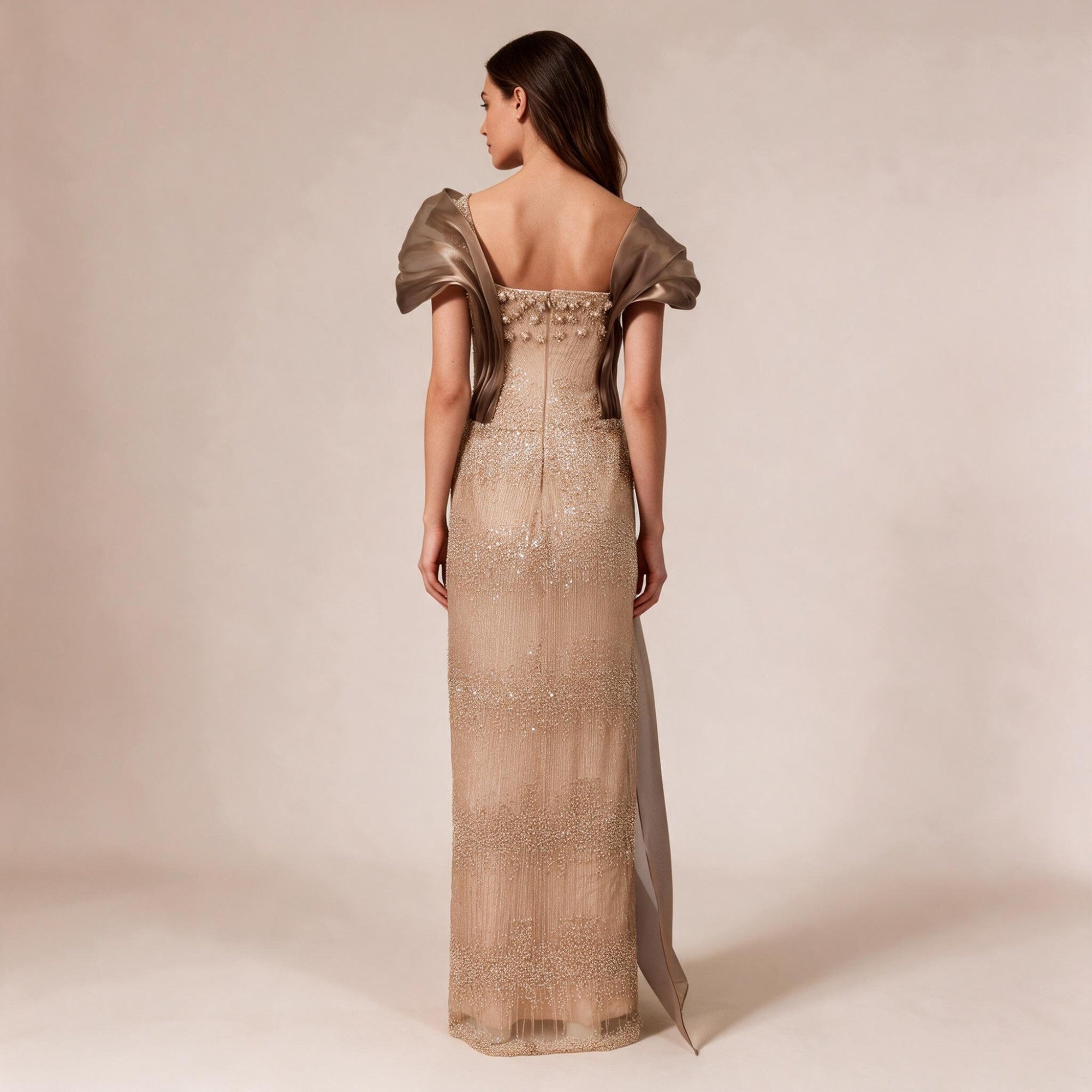 Bronze floor-length gown with square back neckline, puffed satin sleeves, beaded bodice, and sequined skirt with a flowing sa
