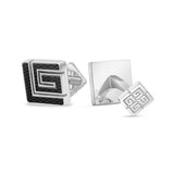 Pair of silver-toned cufflinks. One has a black carbon fiber inlay forming a stylized 'G' pattern. The other has a square tog