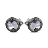 Pair of gunmetal-toned cufflinks with white mother-of-pearl centers, engraved 'GUY LAROCHE', and two geometric shapes. Silver
