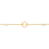 Gold-toned chain bracelet with a central white mother-of-pearl ring charm featuring gold-toned logo details, flanked by two w