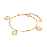 Gold-toned chain bracelet with three round charms (white iridescent centers, patterned borders), four clear stones, and a G-l